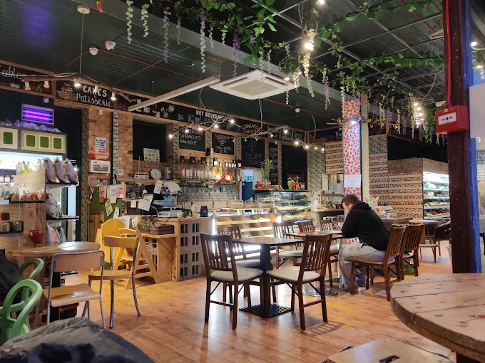 Cafe interior with plants, tables and counter