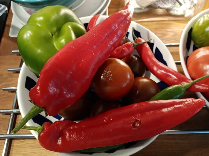 Fresh chillies, peppers and tomatoes in a bowl